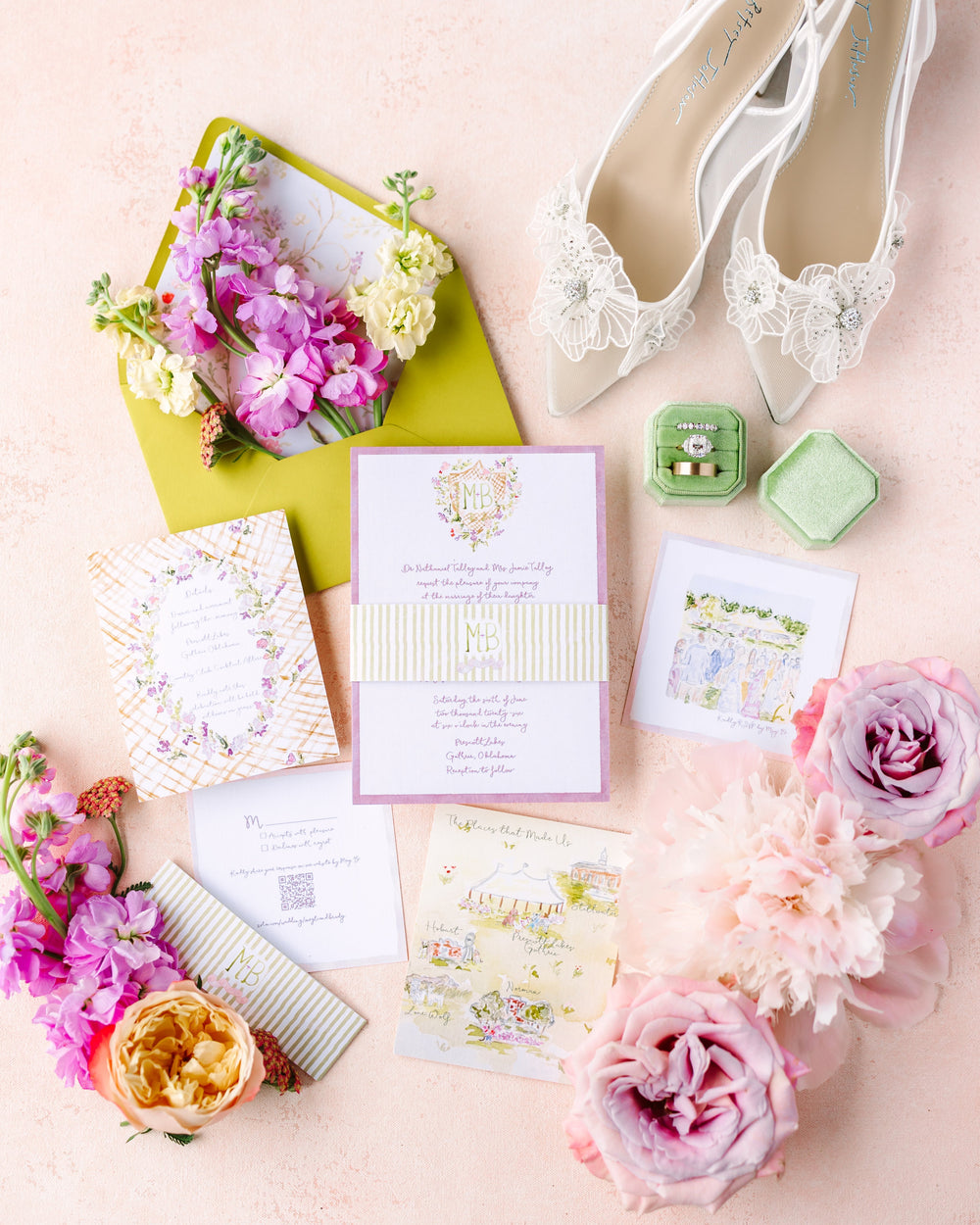 Wedding accessories including shoes, invitations, and flowers on a light background